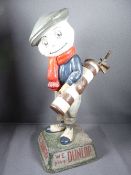 STANDING COMPOSITION FIGURE titled 'We Play Dunlop' of a golfer, his face in the form of a golf ball