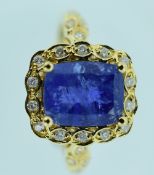 18CT YELLOW GOLD TANZANITE & DIAMOND RING featuring one cushion cut tanzanite (4.12ct) with twenty-