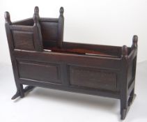 NINETEENTH CENTURY OAK CRIB with acorn finials