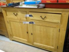 A MODERN LIGHT OAK DRESSER / SIDEBOARD with a plank style top, two drawers and a two cupboard