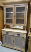 A STRIPPED PINE TWO DOOR UPPER GLAZED DRESSER with a single drawer and two door cupboard base and