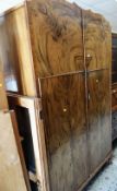 EARLY 20TH CENTURY FLAME MAHOGANY EFFECT SHAPED TOP TWO DOOR WARDROBE retailed by Beere Brothers,