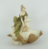 ROYAL DUX FIGURE OF A SEATED FEMALE FILLING A WATER JAR, seated on a shell