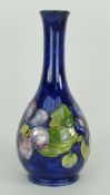 MOORCROFT 'HIBISCUS' POTTERY TALL NARROW NECKED decoration to a blue ground, with Queen Mary sticker