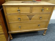 LIGHT OAK ARTS & CRAFTS STYLE CHEST OF DRAWERS on raised turned legs, two short above two long with