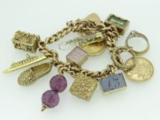9CT GOLD FLAT LINK CURB CHARM BRACELET having an assortment of mainly 9ct gold charms and a Sydney