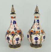 PAIR OF ROYAL CROWN DERBY IMARI PATTERNED, NARROW NECK LIDDED VASES (as found)