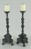 PAIR OF SCANDINAVIAN PEWTER CANDLESTICK HOLDERS on shaped tripod bases, 36cms high