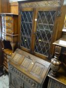 VINTAGE OAK LINEN-FOLD BUREAU BOOKCASE having two door glazed top, 175cms tall
