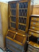 VINTAGE OAK BUREAU BOOKCASE on raised baluster legs with lead glazed upper doors
