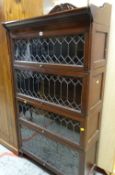 FOUR SECTION GALLERY TOPPED GLOBE WERNICKE STYLE BOOKCASE with leaded glass front