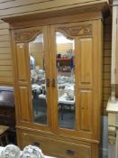 AN EDWARDIAN & SATINWOOD TWO MIRROR DOORED WARDROBE with single drawer base and carved frieze