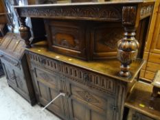 VINTAGE OAK COURT CUPBOARD with carved decoration, with two drawers and a two cupboard base,