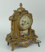 FRENCH TWO TRAIN GILT METAL MANTEL CLOCK decorated with porcelain panels, with key together with