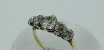 YELLOW METAL (BELIEVED 18CT GOLD) DIAMOND FIVE-STONE RING