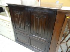 DARK OAK LINEN-FOLD STYLE ENTERTAINMENT CABINET, together with a vintage mahogany break-front