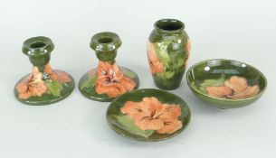 FIVE ITEMS OF MOORCROFT 'HIBISCUS' POTTERY in green ground, some with the Queen Mary sticker