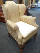 GOOD QUEEN ANNE STYLE WING BACK ARM CHAIR in gold floral upholstery, with carved ball and claw