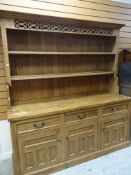 MODERN PINE KITCHEN DRESSER with fret work top, and three cupboard base, 198cms tall x 183cms wide