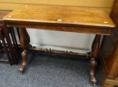 VICTORIAN WALNUT FOLDOVER CARD TABLE having base lined interior and on carved lyre supports with