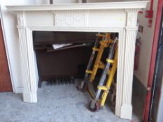 LARGE WHITE PAINTED WOODEN FIRE SURROUND with classical decoration and Corinthian column sides,