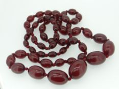 STRING OF GRADUATED CHERRY RED AMBER BEAD NECKLACE