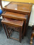 A NEST OF THREE ORIENTAL HARDWOOD COFFEE TABLES with open work carved frieze, largest 46cms wide