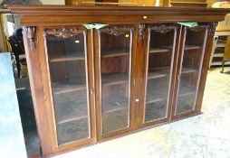 EARLY 20TH CENTURY MAHOGANY CUPBOARD BOOKCASE with carved decoration to the doors and sides and