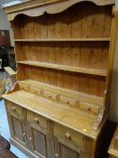 PINE DRESSER having open rack with spice drawers, cupboard and drawers to the base, 198cms h x
