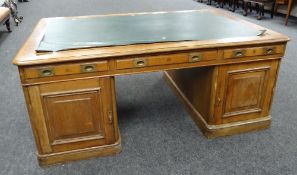LARGE TURN OF THE CENTURY OAK PARTNERS DESK having two opposing banks of eight drawers, green
