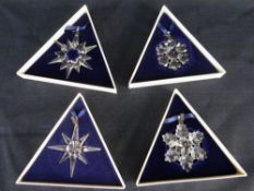FOUR BOXED SWAROVSKI CRYSTAL LIMITED EDITION CHRISTMAS SNOWFLAKE ORNAMENTS (1994-1997)