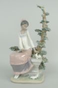 LLADRO MODEL OF AN AFRO-CARIBBEAN GIRL IN PINK DRESS seated against a fir tree with doves