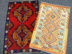 TWO RUGS comprising blue and red ground geometric Baluchi rug, 138 x 89cms and an orange and brown