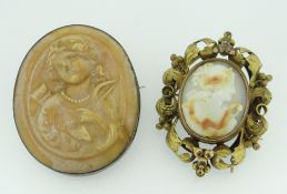 LAVA TYPE CAMEO BROOCH, together with another cameo brooch with scroll and foliate surround, box