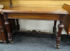 VICTORIAN MAHOGANY SIDE-TABLE of rounded rectangular form and with caved supports and stretchers