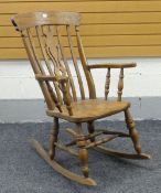 20TH CENTURY OAK WINDSOR TYPE ROCKING CHAIR with shaped and pierced centre splat
