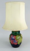 WILLIAM MOORCROFT POTTERY 'HIBISCUS' PATTERN TABLE LAMP with green / blue ground (ginger jar