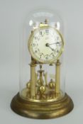 GERMAN GILT METAL ROTARY CLOCK in a glass dome with circular enamel dial by Schatz