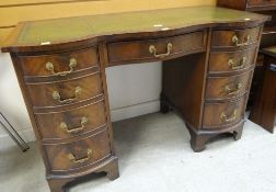GOOD REPRODUCTION SERPENTINE DESK having brass handles, tooled and leather top, 75cms h x 115cms w