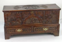 AN INTERESTING 19TH CENTURY WELSH OAK CARVED COFFER CHEST on bracket feet with two base drawers