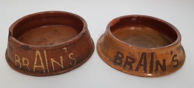 TWO EWENNY POTTERY SPITTOONS FOR BRAINS BREWERY both of circular form and slip inscribed 'RED DRAGON