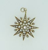 YELLOW METAL DIAMOND AND PEARL STARBURST DESIGN PENDANT set with graduated seed pearls and
