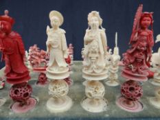 CHINESE IVORY CHESS MEN in natural and red-stained ivory, carved as emperors, horseback warriors,