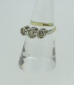 18CT YELLOW AND WHITE GOLD THREE STONE DIAMOND RING, the illusion set stones approximately 0.25cts