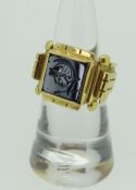 YELLOW METAL INTAGLIO RING depicting the head of a Roman legionnaire, (tested as high carat
