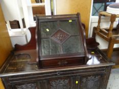 VINTAGE CONTINENTAL MAHOGANY HANGING CORNER WALL CUPBOARD with four section green glass door, centre