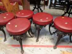 FIVE CAST METAL CIRCULAR CUSHION TOP STOOLS