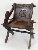 OAK GLASTONBURY CHAIR the back carved with roundel motif and with Latin script to both sides of each