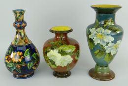THREE DOULTON LAMBETH VASES (1) Faience series of bottle form with knopped neck and floral