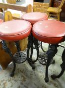 THREE CAST METAL CUSHION TOP BAR STOOLS